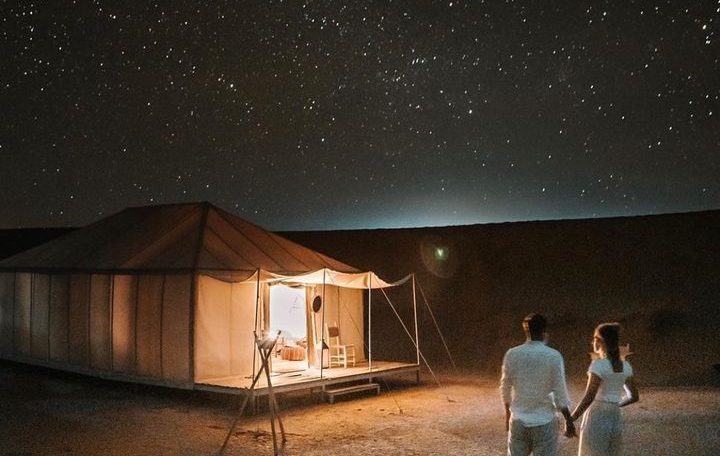 Traditional Berber camp lit up at night in the Erg Chebbi desert