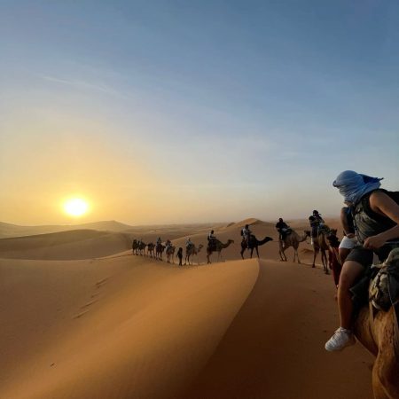 Sunset Camel Trek in Merzouga Desert Camel caravan during sunset in the Erg Chebbi dunes, Merzouga