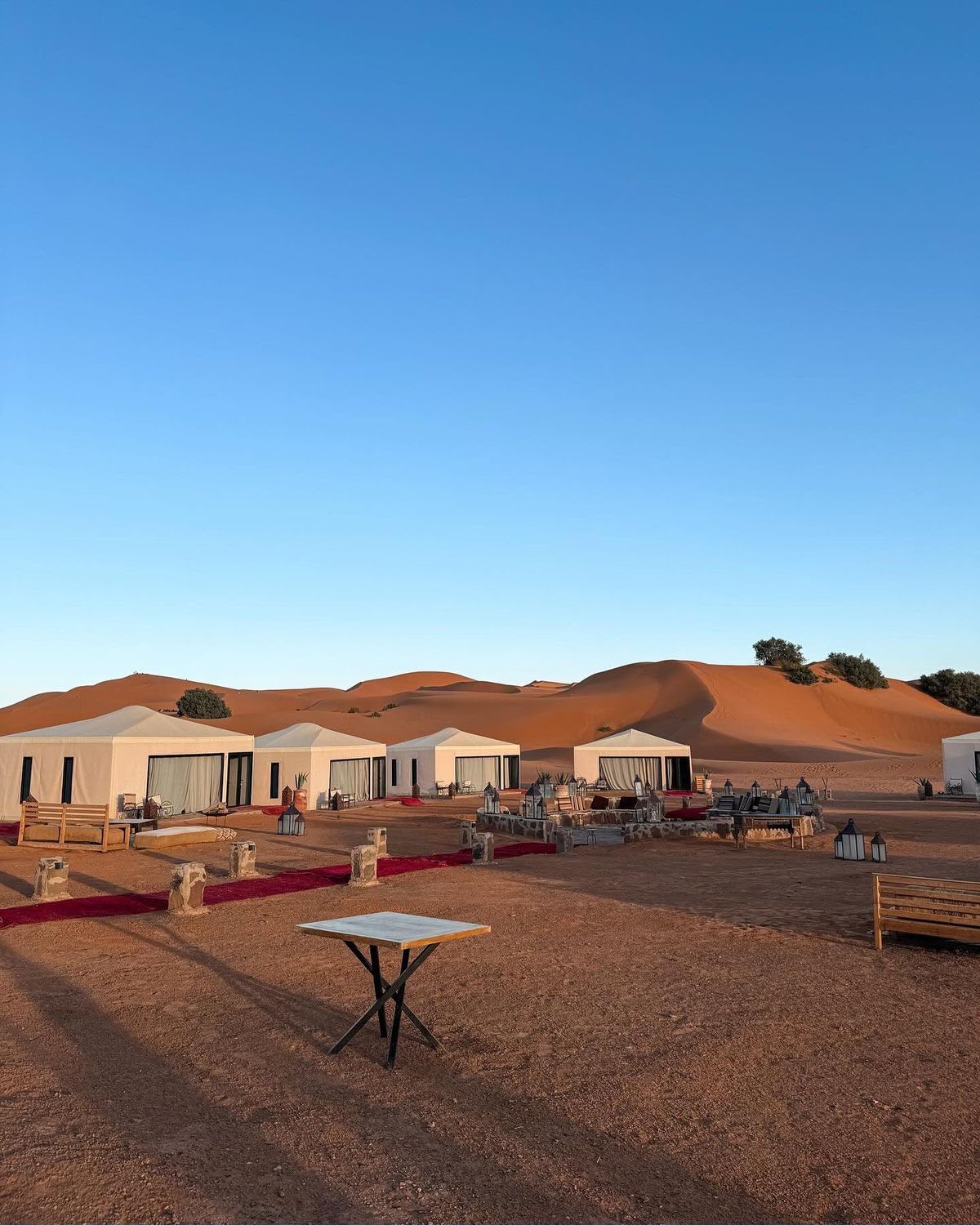 Sunset camel trekking beside an Erg Chegaga desert camp